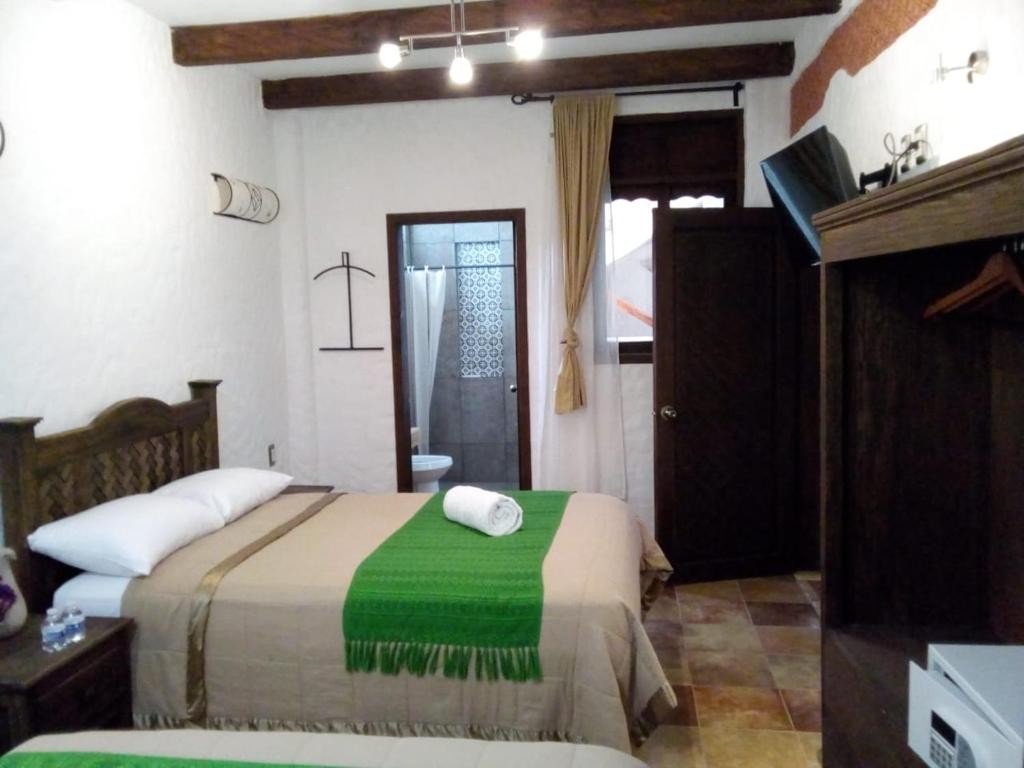 Hotel Na´Lum room with wooden beams and traditional furnishings